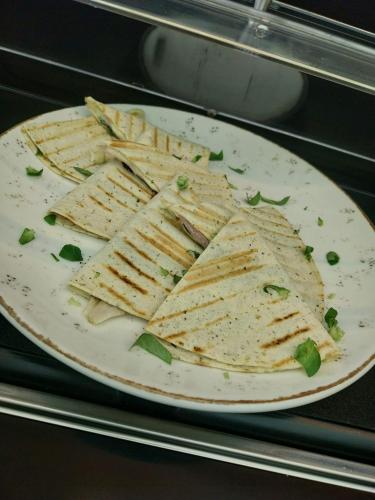 a plate of crackers on top of a microwave at Hotel Novotheos in Oradea