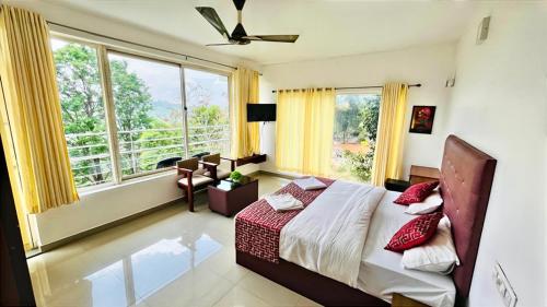 a bedroom with a bed and a large window at Elenji Vitara Resort Munnar in Munnar