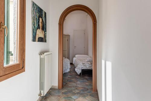 - un couloir avec une arche dans une chambre avec un lit dans l'établissement Great Apartment at the Duomo, à Florence