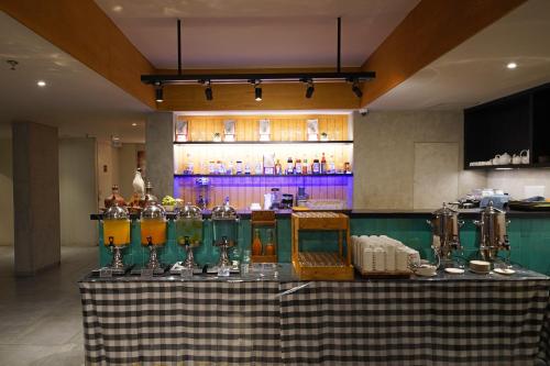 a table in a room with a counter with drinks at Episode Kuta Bali in Kuta