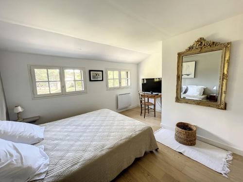 a bedroom with a large bed and a mirror at Maison Saint-Pair-sur-Mer, 5 pièces, 8 personnes - FR-1-361-56 in Saint-Pair-sur-Mer