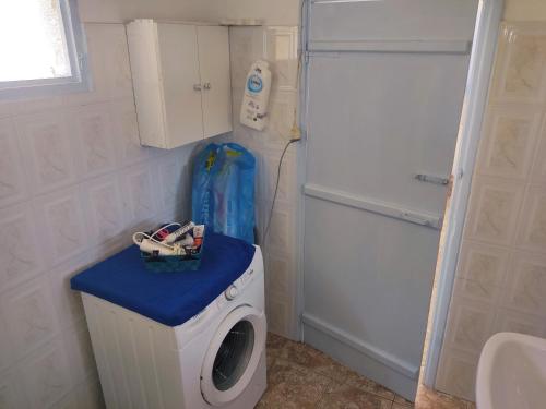 a washing machine in a bathroom with a washer at Calliope's house in Lipsoi