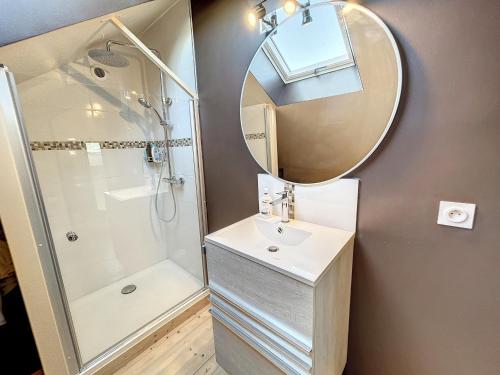 a bathroom with a shower and a sink and a mirror at Maison rénovée 3 chambres, proche mer, jardinet équipé, centre-ville - FR-1-361-464 in Jullouville-les-Pins