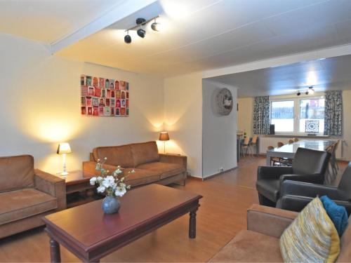 a living room with couches and chairs and a table at Holiday home in ldernTwistetal Oberwaro with sauna in Oberwaroldern