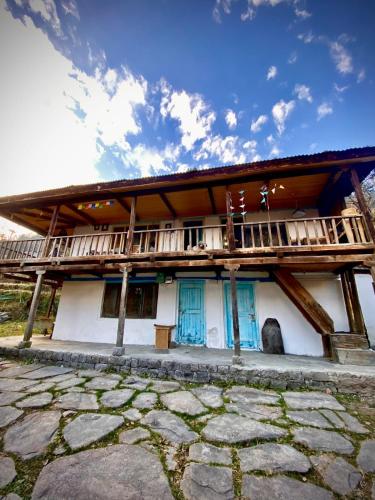 un edificio con puertas azules y balcón en Arthome by Doghari Stays, en Manali