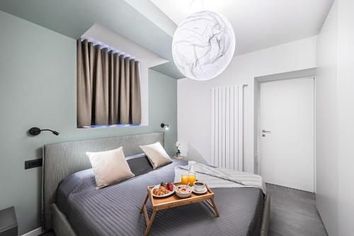 a bedroom with a bed and a table with food on it at Gemhouse Smeraldo garda lake in Gargnano