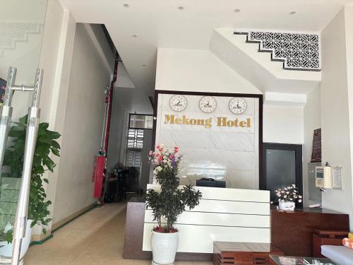 a welcome hotel sign in a lobby with flowers at Hotel Me Kong in Ha Long