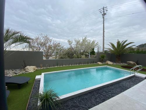 a swimming pool in a yard with a fence at ＩＲＡＧＯ　ＡＲＴ　 ＨＯＴＥＬ 　THECAPE in Irago