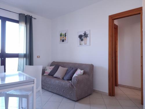 a living room with a couch and a table at Casa Vecchio Mulino in Budoni