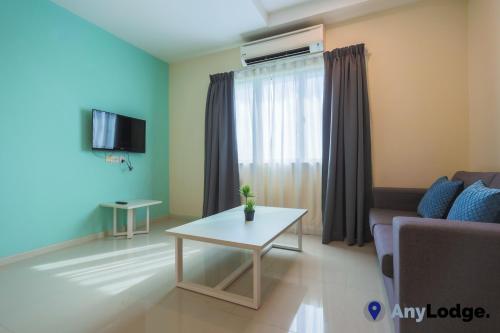 a living room with a couch and a table at AnyLodge Waterfront Marina Island Pangkor in Lumut