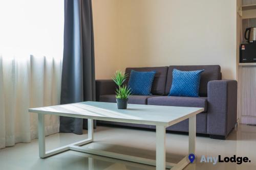 a coffee table in a living room with a couch at AnyLodge Waterfront Marina Island Pangkor in Lumut