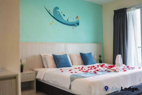 a bedroom with a bed with red rose petals on it at AnyLodge Waterfront Marina Island Pangkor in Lumut