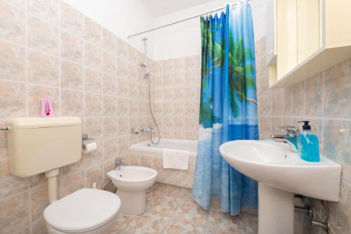 a bathroom with a toilet and a sink at Rooms Olive and Sea in Tučepi