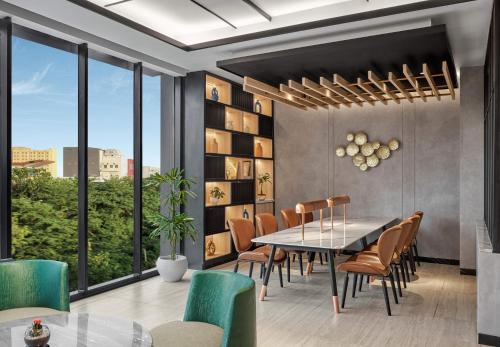 a dining room with a table and chairs at Hyatt Place Makassar in Makassar