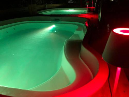 a swimming pool with red lights in a room at ConcaverdeClub in Sogliano al Rubicone