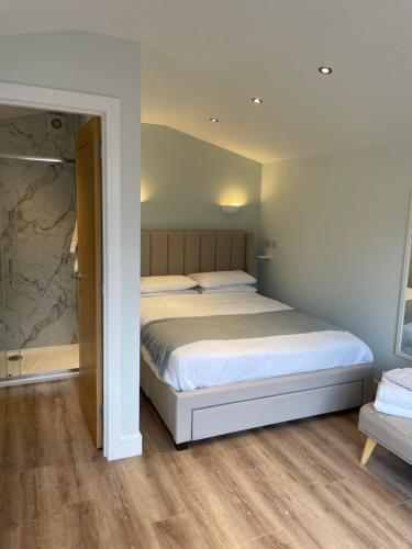 a bedroom with a large bed and a chair at The Grove Cabin in Fort William