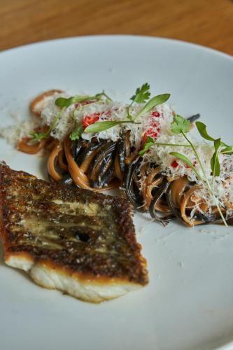a plate of food with pasta and bread on a table at Fairlawns, Hotel And Spa in Walsall