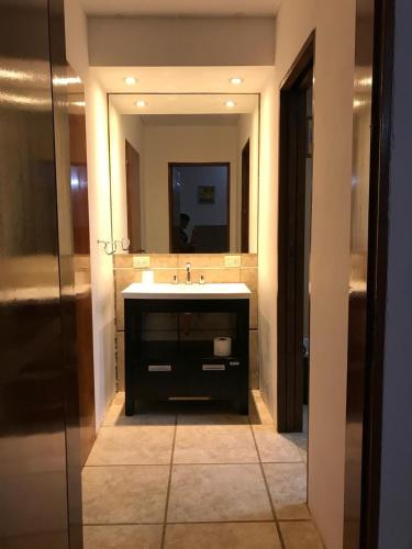 a bathroom with a sink and a mirror at Refugio costero in Pinamar