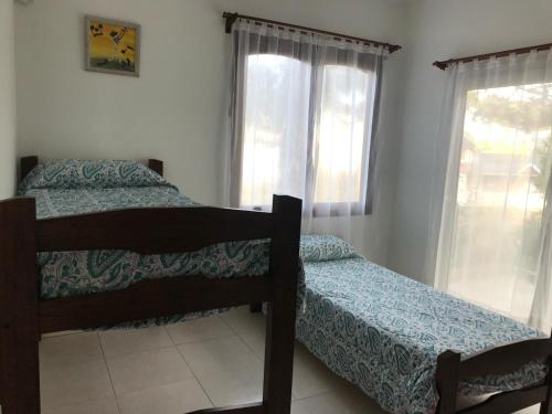 a bedroom with two beds and a window at Refugio costero in Pinamar