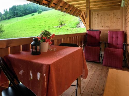 a table in a room with a view of a field at Cosy farmhouse apartment at the edge of the forest in Mühlenbach