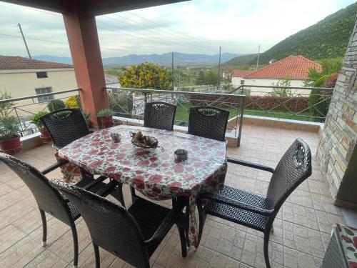 una mesa y sillas en un balcón con vistas en VILLA NIKOLETTA en Eleftheroúpolis