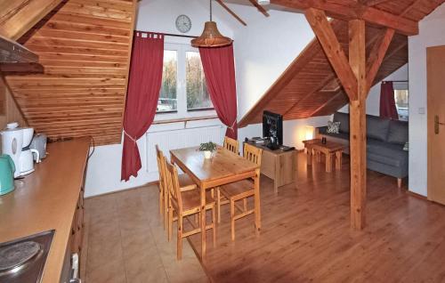 a kitchen and living room with a table and chairs at 1 Bedroom Pet Friendly Apartment In Grnow in Grünow