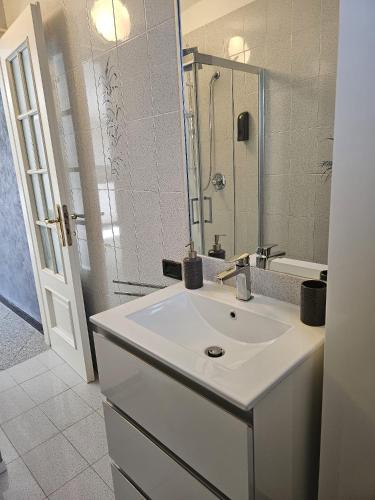 a bathroom with a white sink and a mirror at La Casa della Lavanda in Borgo Adorno