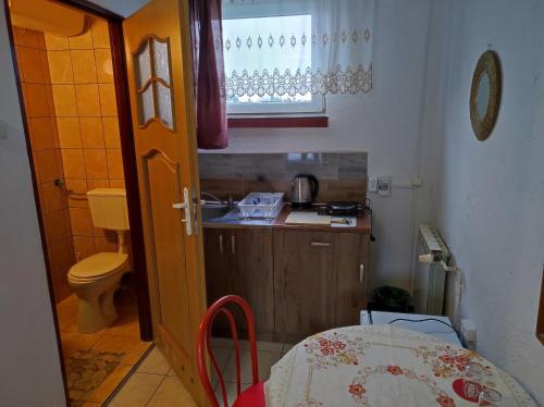 a small kitchen with a sink and a table in a room at Motel Korona in Zamość