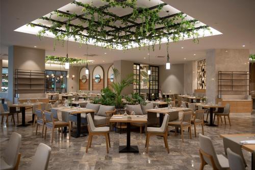 a restaurant with tables and chairs in a room at Miramare Beach Hotel - Ultra All Inclusive in Side