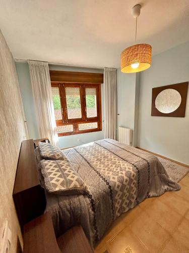 a bedroom with a bed and a window at Del Valle 3 in Cudillero