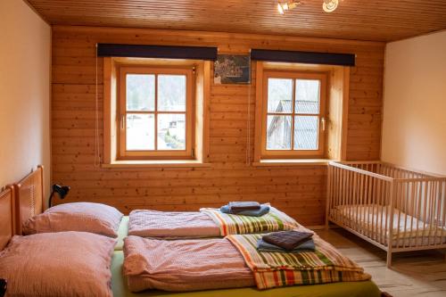 a bedroom with two beds in a room with windows at Apartment Haider 1 in Obertraun
