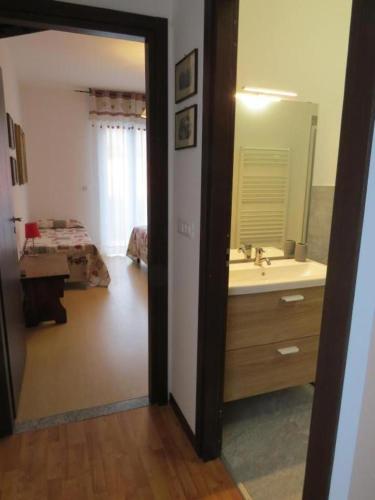 a bathroom with a sink and a mirror at CASA AZZURRA Domodossola FREE PARKING in Domodossola