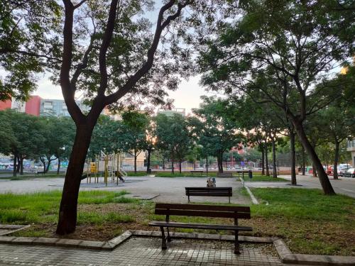 a park with a bench and trees in a park at Paul's Rooms, no se admiten turistas not for tourists in Valencia