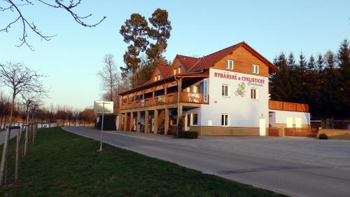 a large building on the side of a road at Penzion Terasa při Rybářském a cyklistickém centru in Chlum u Třeboně