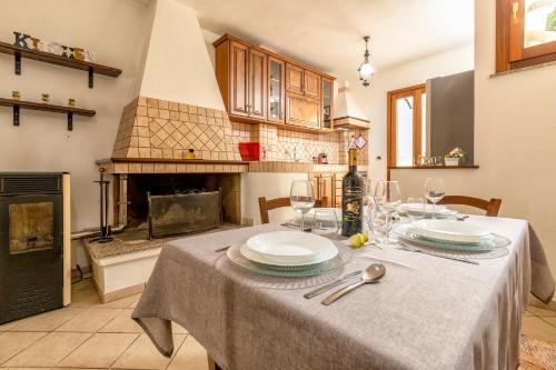 a kitchen with a table with plates and wine glasses at Appartamento Libio Porto Torres in Porto Torres