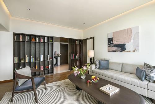 a living room with a couch and a table at The Oberoi Mumbai in Mumbai