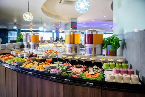 a buffet line with many different types of food at The Capital Pearls Hotel in Durban