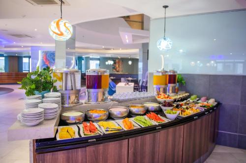 a buffet line with many different types of food at The Capital Pearls Hotel in Durban