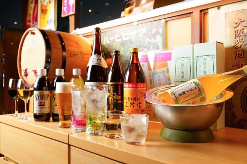 a bunch of bottles of wine and glasses on a counter at Spa and Resort Hotel Solage Oita Hiji Beppuwan in Beppu