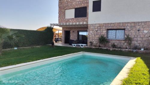 - une piscine en face d'une maison dans l'établissement L'Écrin de Paradis, à Sousse