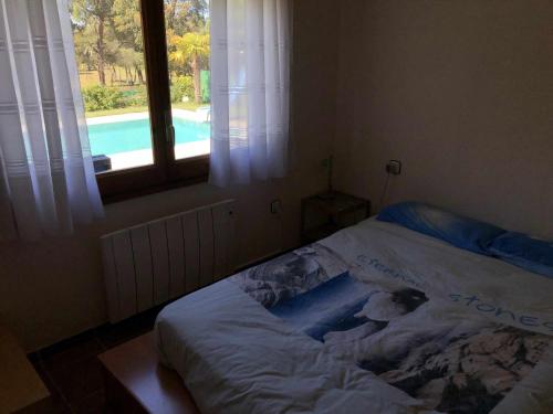 ein Bett in einem Schlafzimmer mit einem Fenster und einem Pool in der Unterkunft Casa Bellavista con piscina en Caldes Costa Brava in Caldes de Malavella