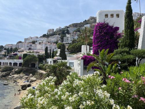 a view of positano from a beach with flowers at Garbinell A - Piso muy bonito, Vistas al mar espec in Roses