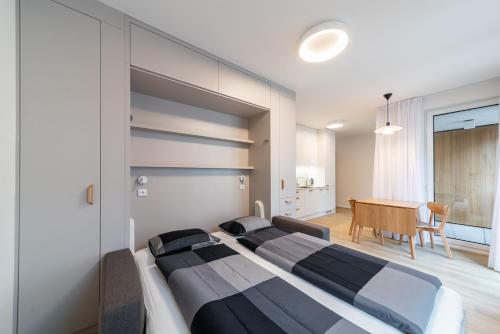 a bedroom with two beds and a table in it at Residence Mozaika in Prague