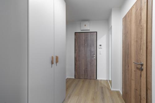 an empty hallway with a wooden door in a room at Residence Mozaika in Prague