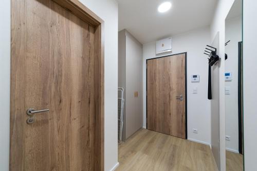 a hallway with a wooden door in a room at Residence Mozaika in Prague