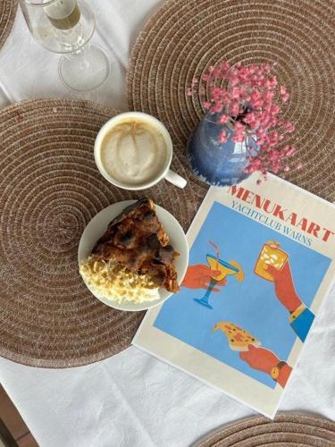 a table with a bowl of food and a cup of coffee at Minicamping Marina Warns in Molkwerum