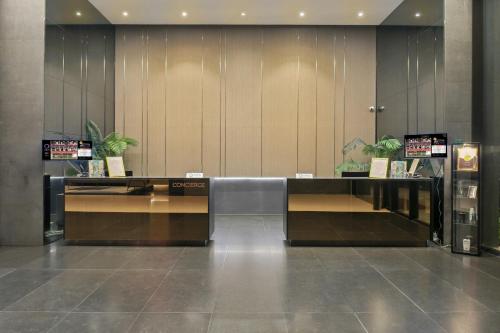 a lobby with a reception desk in a building at Opus Residences by Opus Hospitality in Kuala Lumpur