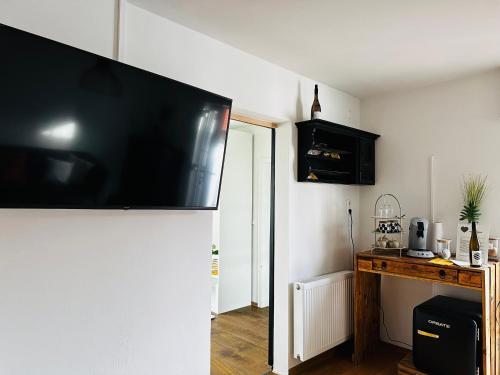 a flat screen tv hanging on the wall of a room at ANINA in Meckenheim