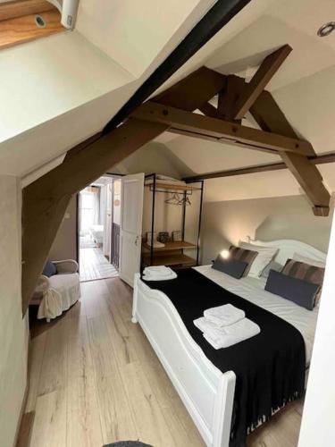 une chambre avec un grand lit dans un grenier dans l'établissement Maison de charme 3 chambres remparts de Guerande, à Guérande