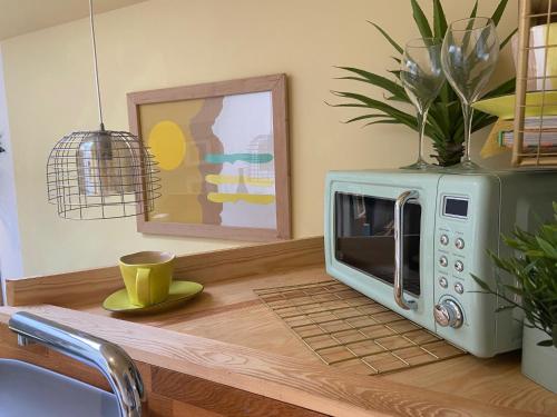 a microwave sitting on top of a kitchen counter at Town Centre Garden Retreat in Cheltenham